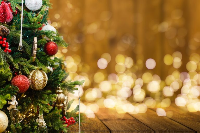 Fir Tree decorated with christmas balls on rustic wood and sparkles light backgorund . High quality photo